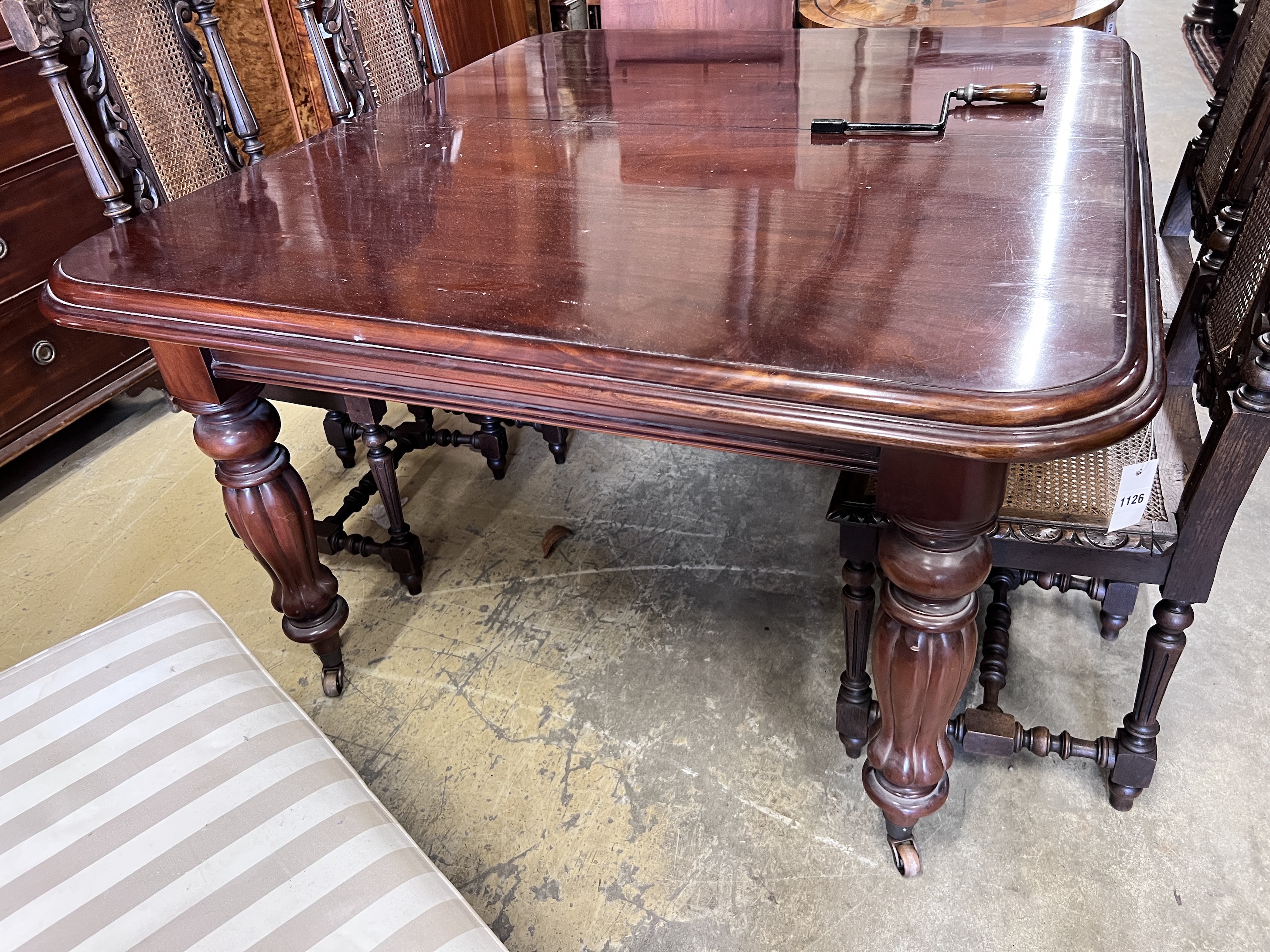 A Victorian style mahogany extending dining table, extends to 235cm, width 124cm, together with a set of eight matching dining chairs